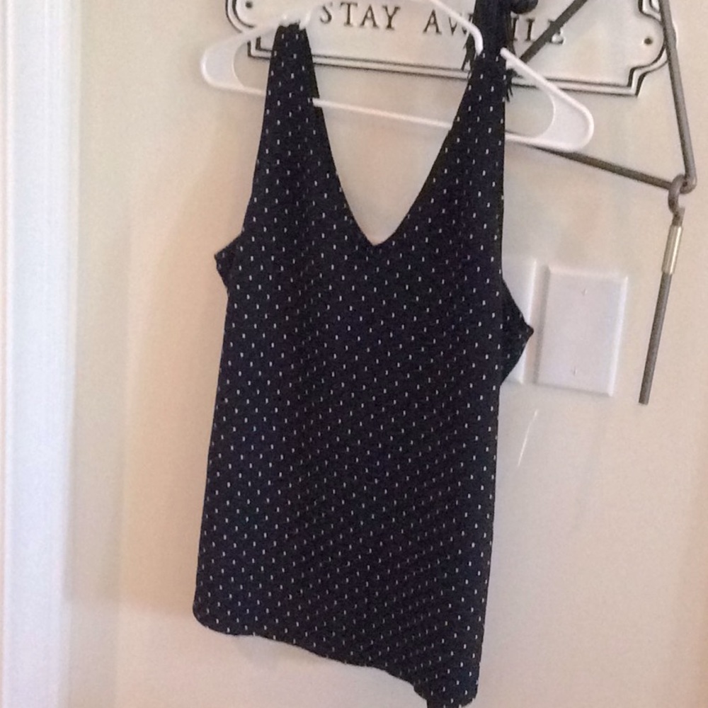 White polka dots on black shirt